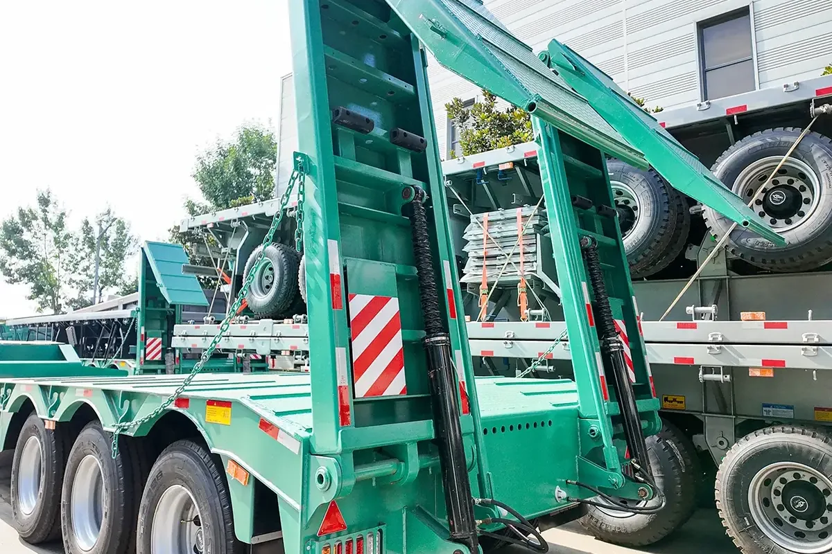 lowbed semi trailer with detachable gooseneck hydraulic ramp structure close-up shot