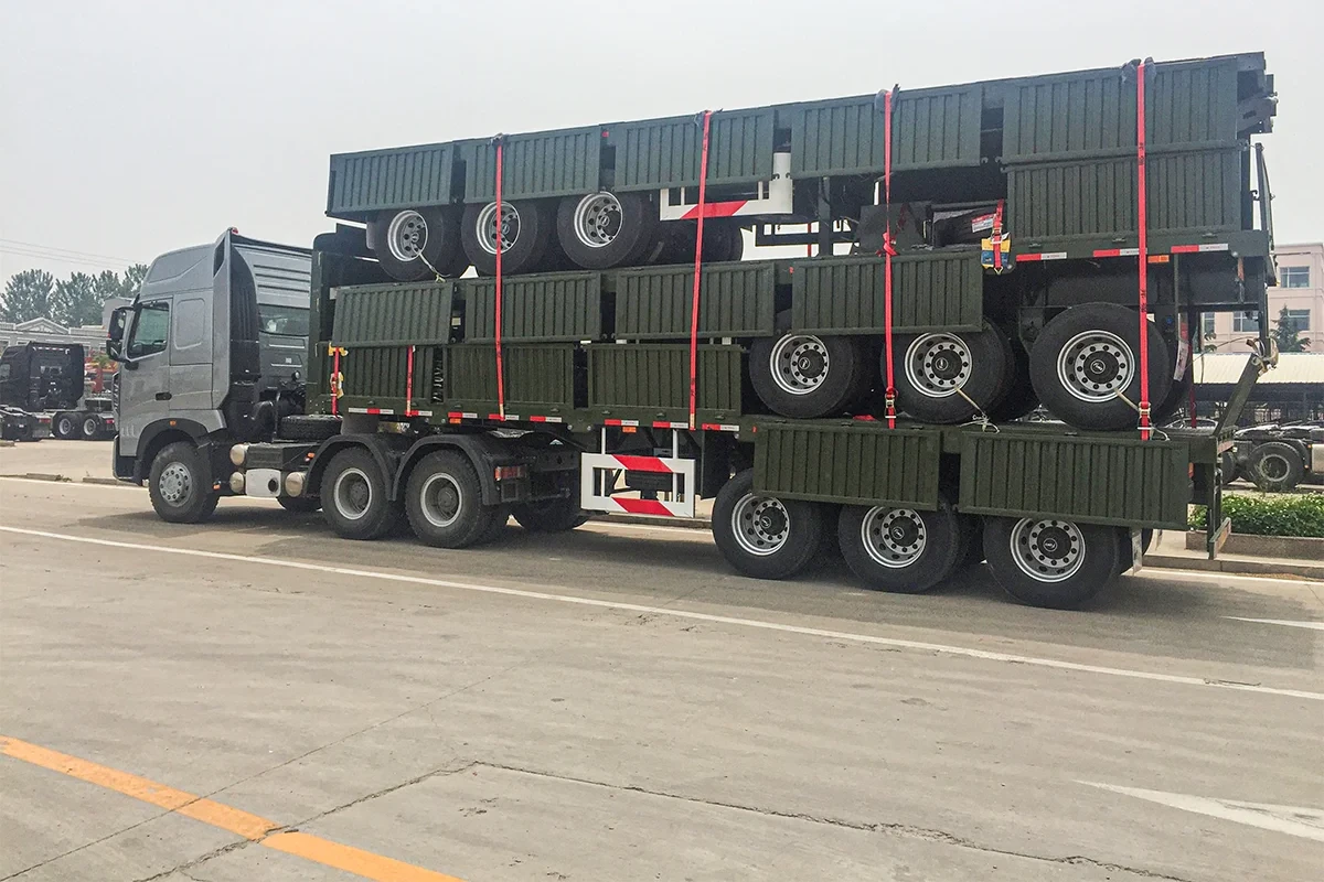 Livestock fence trailers stacked on flatbed for ocean freight
