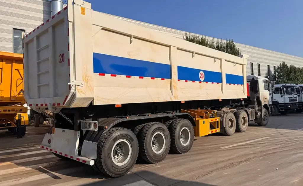 3-axle rear dump semi trailer side view with raised hardox steel cargo box