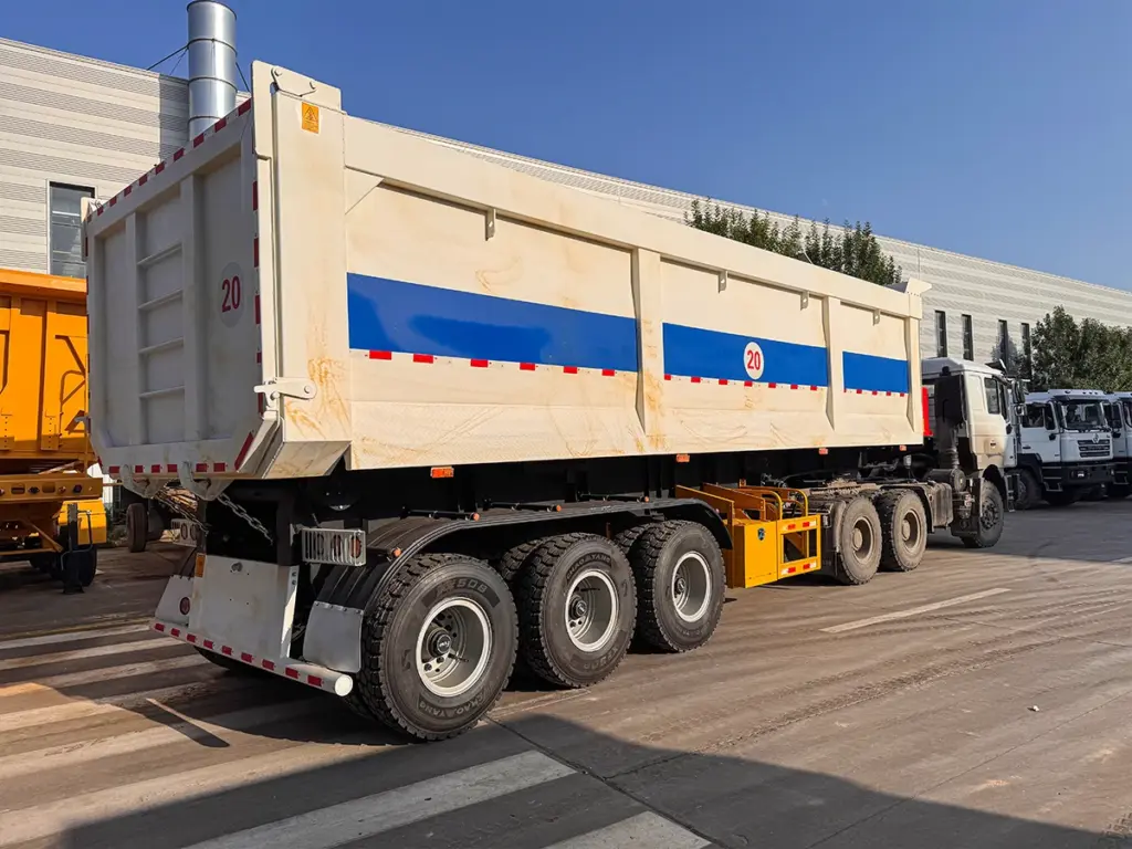 3-axle rear dump semi trailer side view with raised hardox steel cargo box